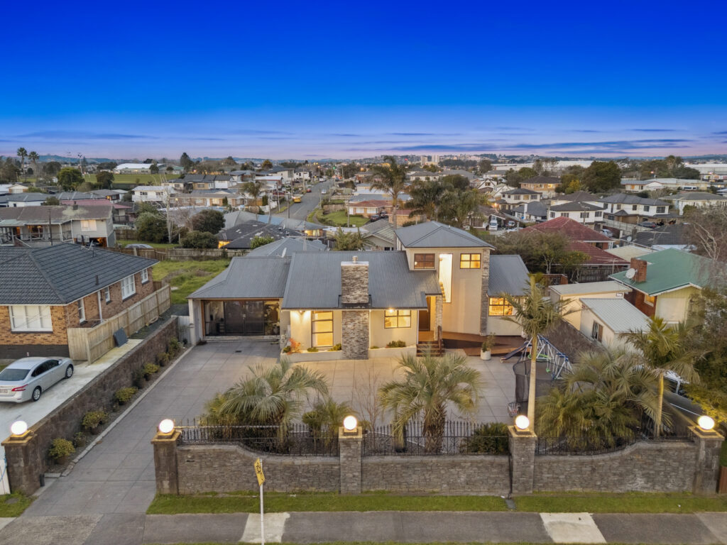 Beautifully lit front entrance of a residential home at dusk for a premium listing